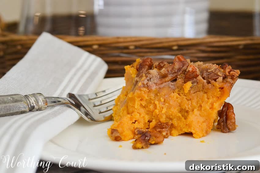 Sweet Potato Casserole with Brown Sugar Pecan Topping 4 Single serving of sweet potato casserole with a fork on the plate.