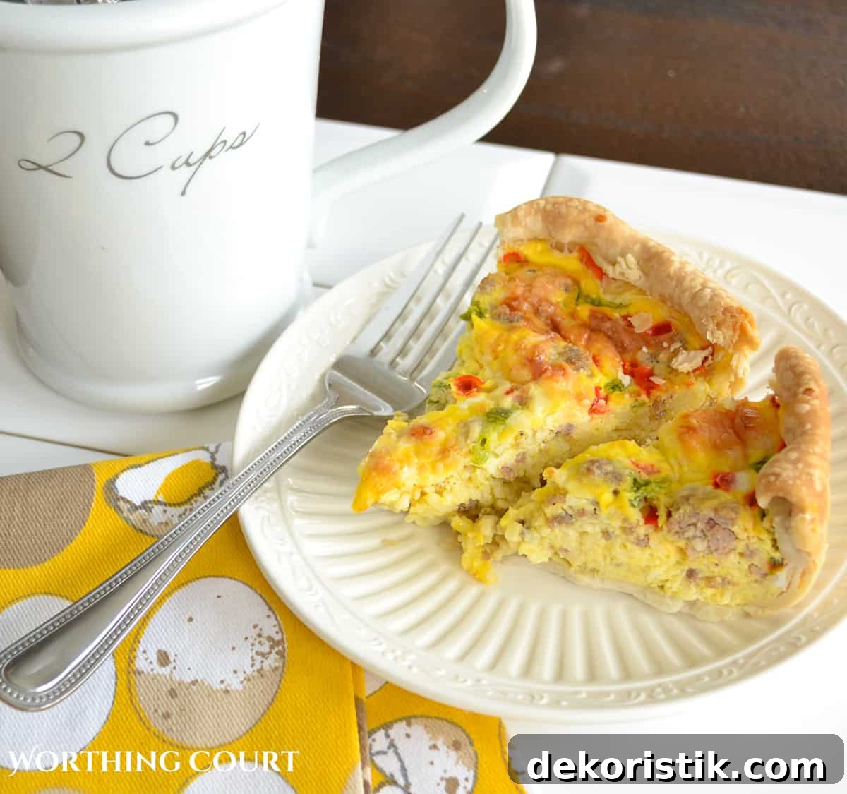 Pieces of sausage and egg breakfast casserole on a white plate with a fork