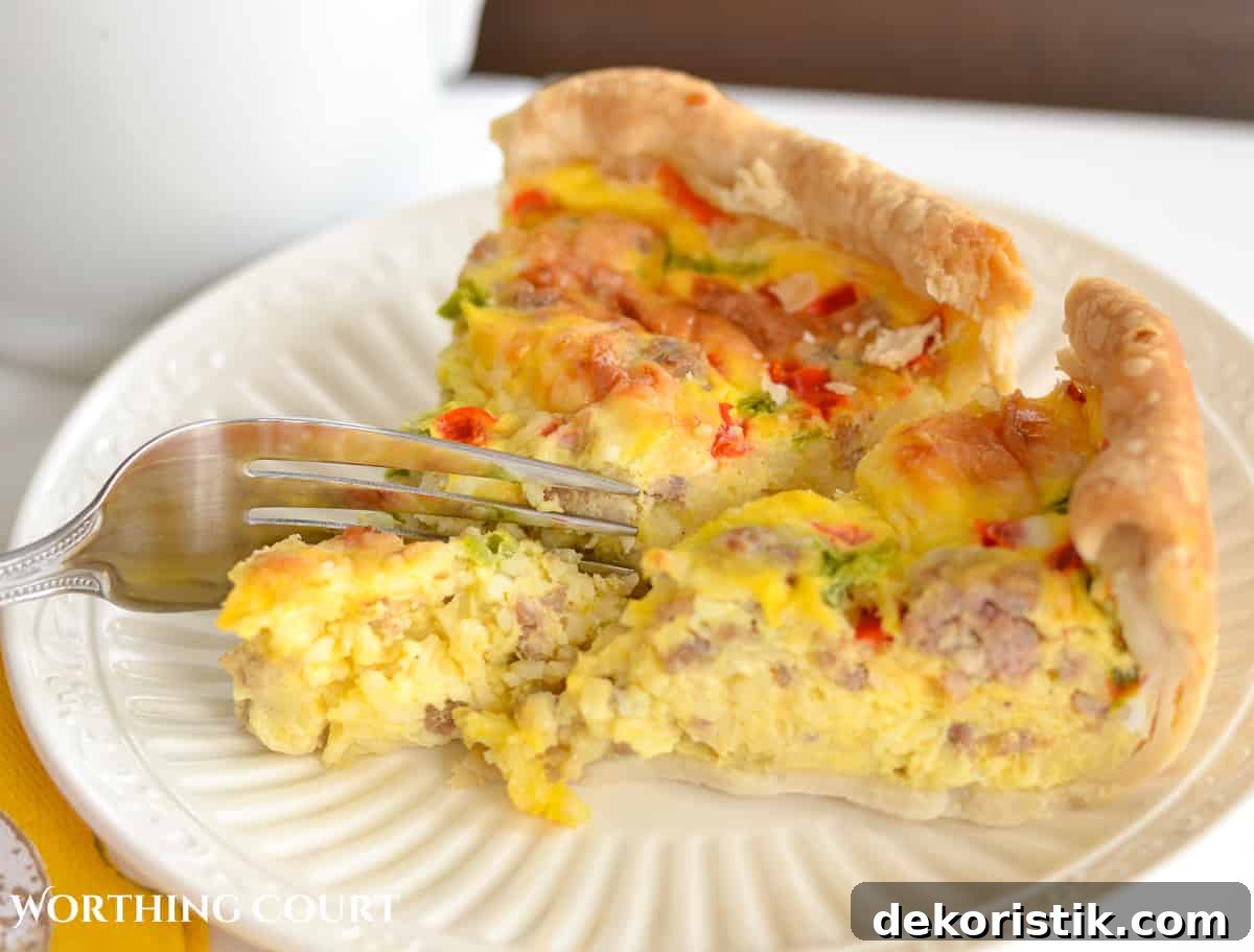 Sausage and egg breakfast casserole piece on a fork cutting into it