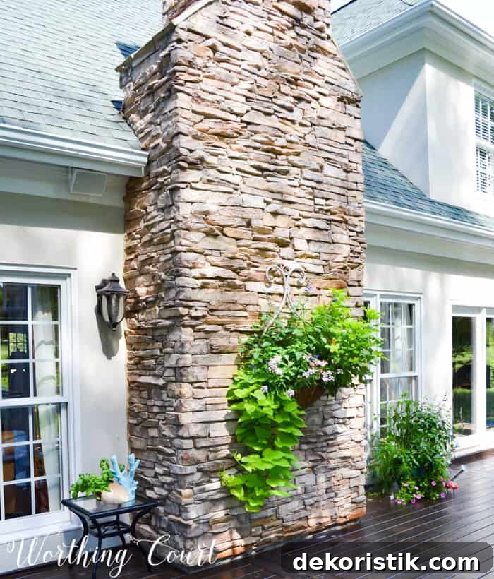 Outdoor planter hanging from rock chimney.