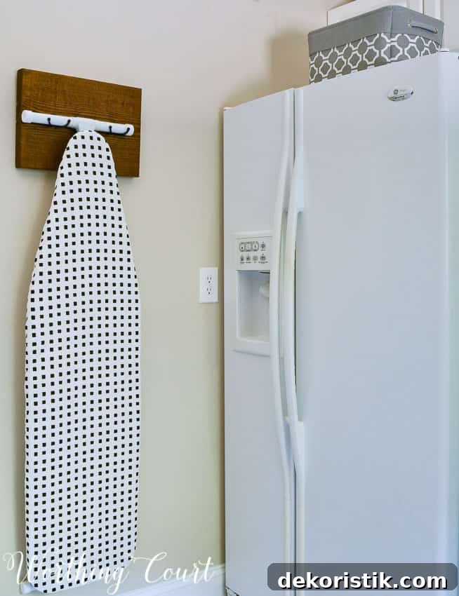 Transform a Cluttered Laundry Room into a Bright, Organized Space 13 DIY ironing board hanger for the laundry room.