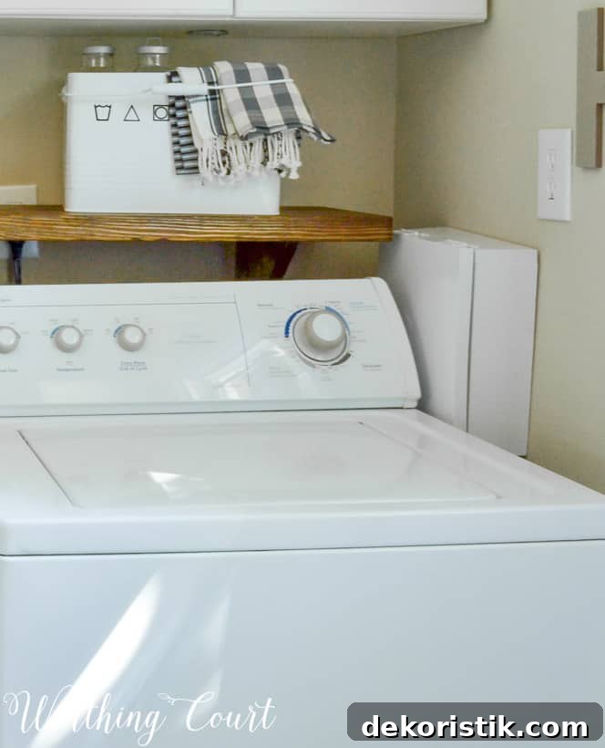 laundry area with washer and access box to side