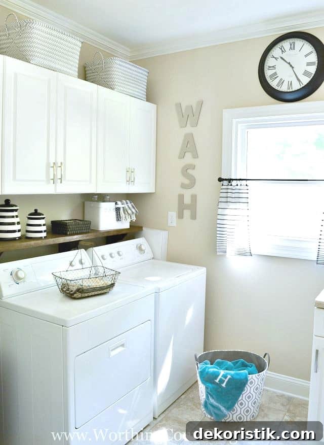 laundry room with white cabinets and white appliances