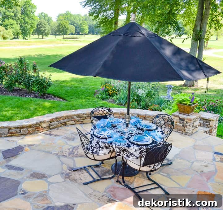 Backyard and Patio Ideas to Transform Your Outdoor Space 12 flagstone patio with an outdoor table and umbrella in a backyard
