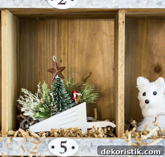 There is a wheelbarrow in a cubby holding a Christmas tree and faux greenery.