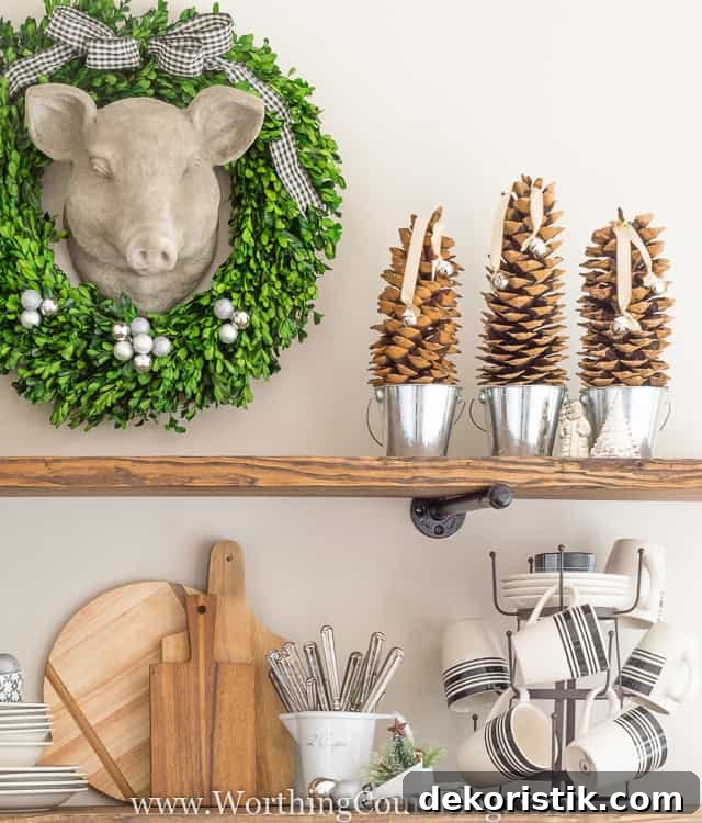 Pine cones are sitting in small silver buckets with bells.
