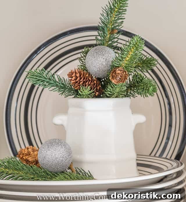 A white crock with faux greener in it and on the plate.