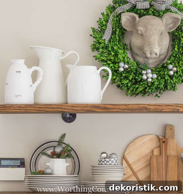 Rustic Farmhouse Kitchen Shelves Decorated For Christmas with white pitches, plates and wooden cutting boards.