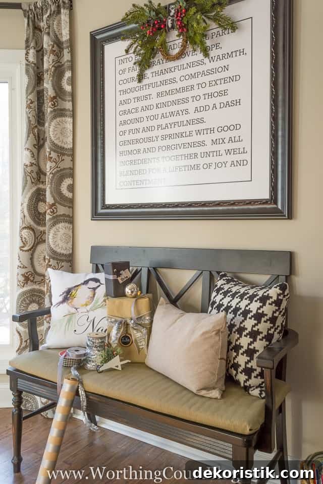 There is a picture on the wall above the sitting bench decorated with a mini wreath.