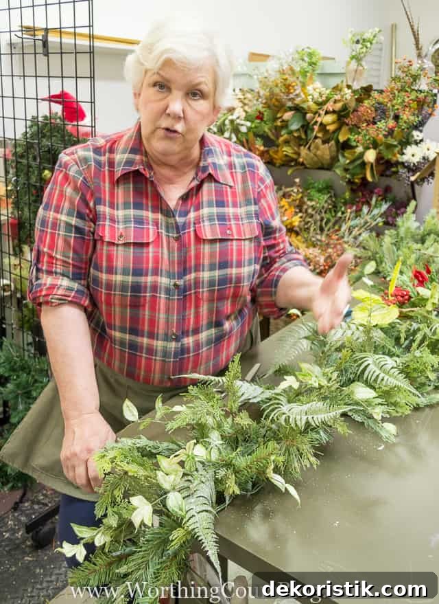 Adding a variety of branches to create texture in the garland.