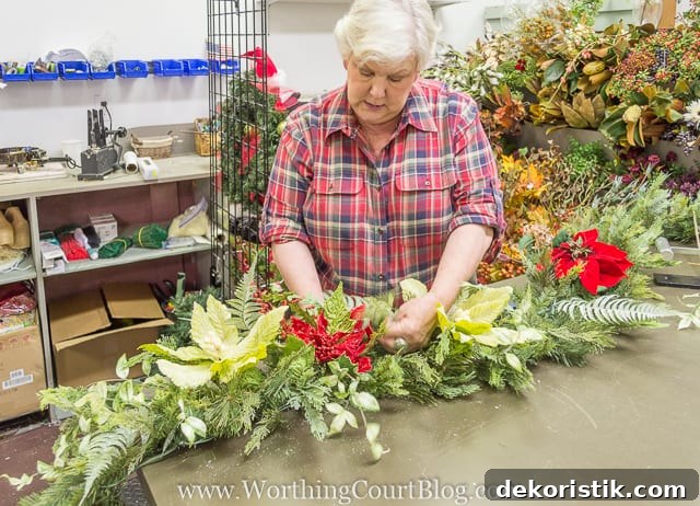 Putting in different types of flowers into the garland.