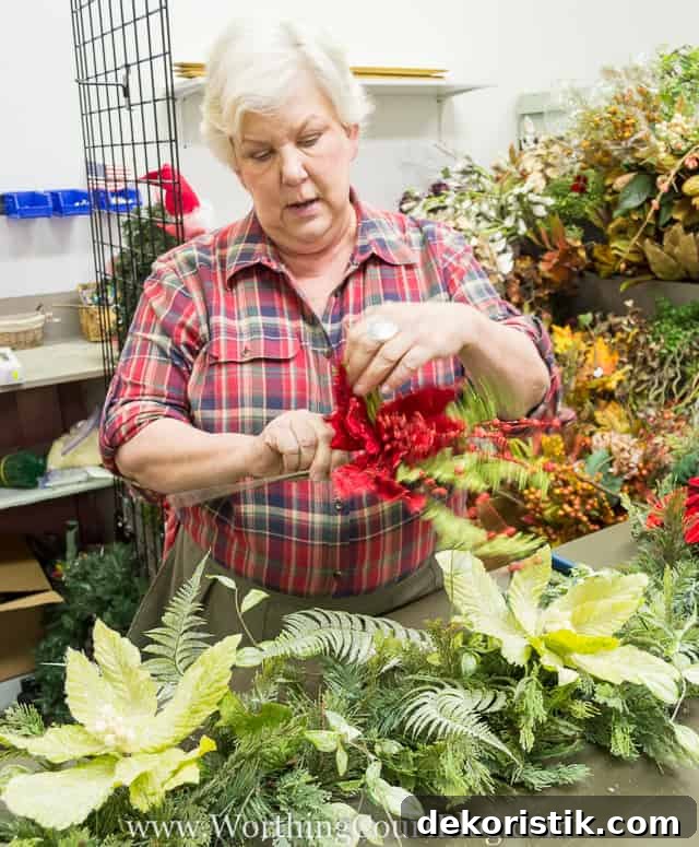 Adding some red berries to the garland.