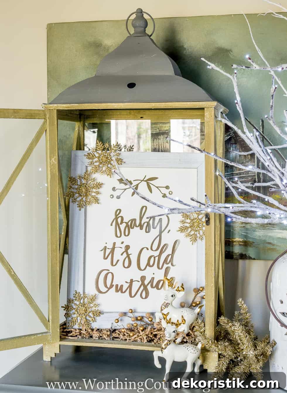 'Baby It's Cold Outside' gold foil print from Minted displayed in a rustic lantern
