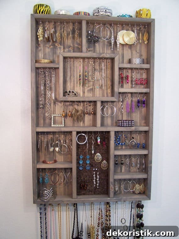 A wall-mounted jewelry shadow box that doubles as art and storage.