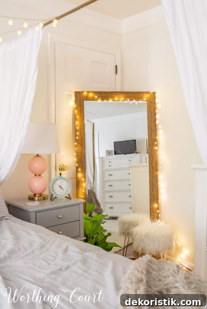 A floor mirror wrapped in string lights to add reflected light and depth.