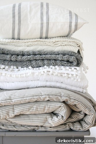 Subtle patterned bedding mixed with solids and color accents.