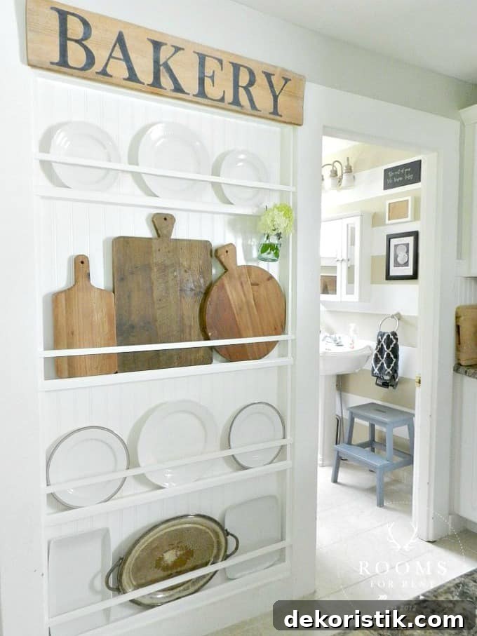 A white plate rack with wooden bread boards and plates on it.