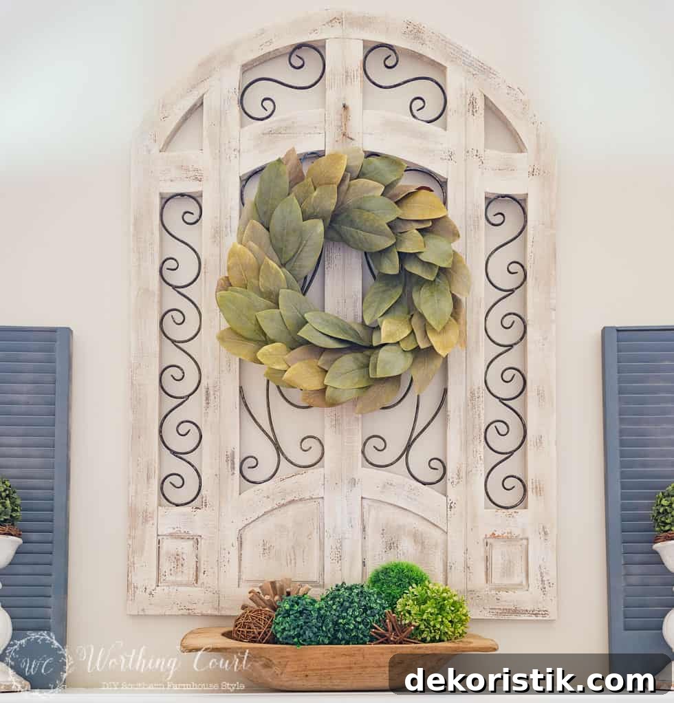 Magnolia wreath centered above the fireplace