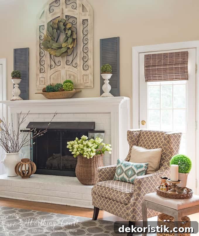 Cozy neutral armchair near the fireplace contributing to the warm family room vignette