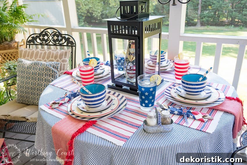 A patriotic table setting on a farmhouse porch filled with loads of red, white and blue vintage Americana patriotic decorating ideas for Memorial Day, Flag Day and July 4th.