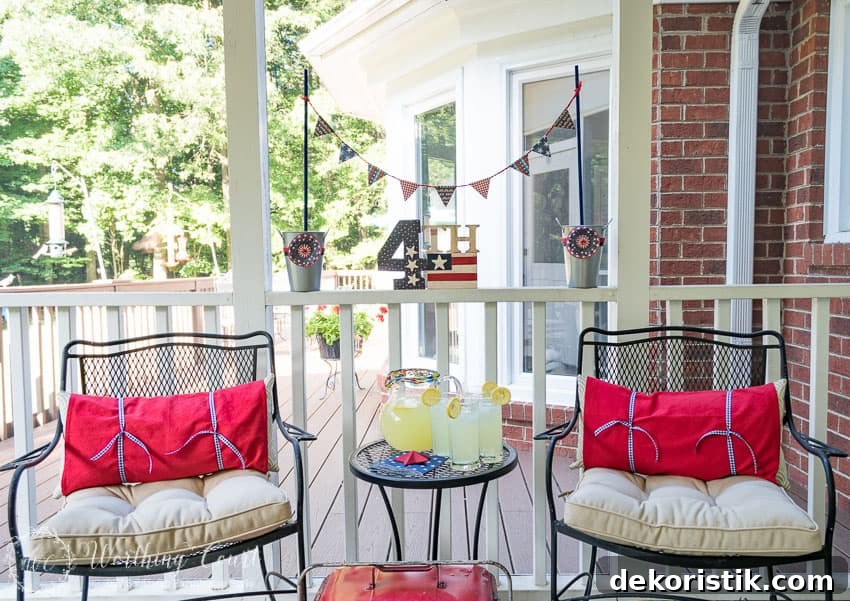 A farmhouse porch filled with loads of red, white and blue vintage Americana patriotic decorating ideas for Memorial Day, Flag Day and July 4th.