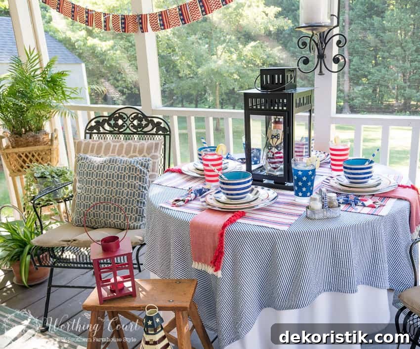 A patriotic table setting on a farmhouse porch filled with loads of red, white and blue vintage Americana patriotic decorating ideas for Memorial Day, Flag Day and July 4th.