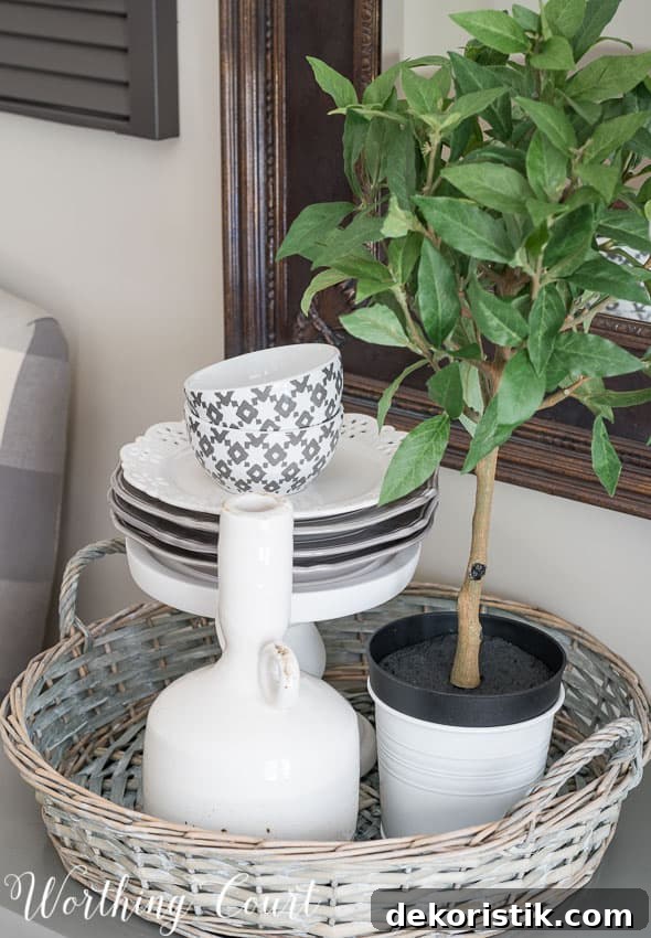 Farmhouse Dining Room Makeover - vignette with stacked dishes on a pedestal inside a round wicker tray