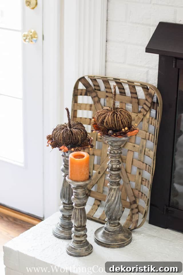 Top various height candlesticks with pumpkins and a candle for an easy fall display.