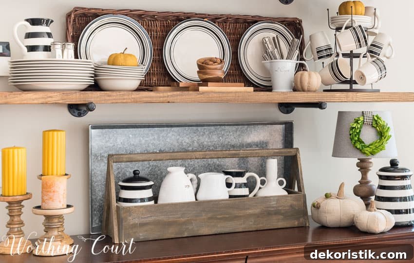The rustic shelves have a wooden toolbox, black and white striped dishes and pitcher and also yellow candles.