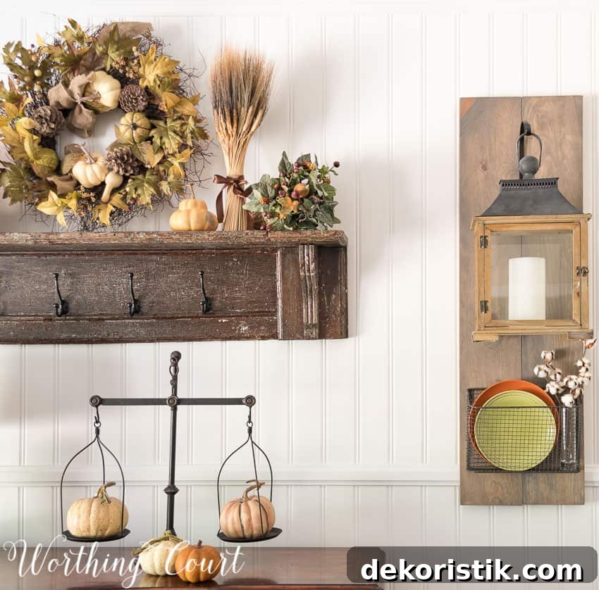 Fixer Upper style hanging lanterns and baskets dressed up for fall and an old fashioned scale with small pumpkins on it.