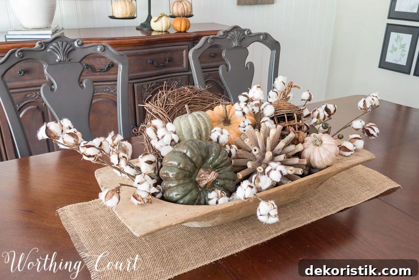 Dough bowl filled with fall goodies, multi colored pumpkins.