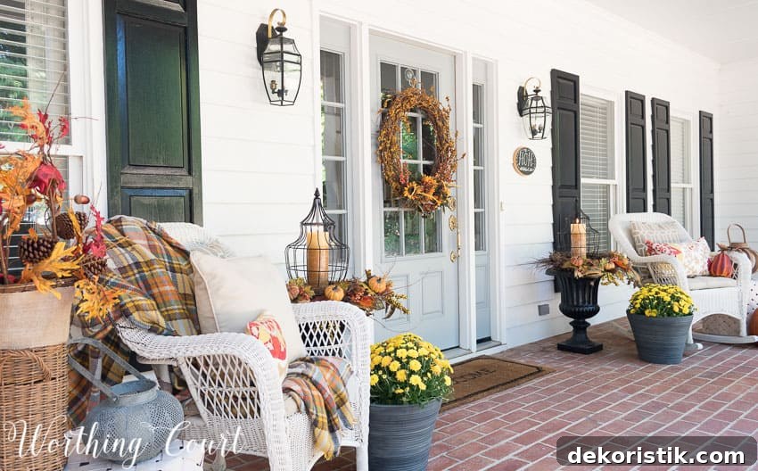 Farmhouse style fall front porch with wicker rockers and fall urns || Worthing Court