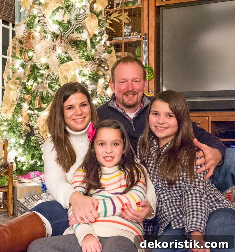 5 Christmas Prep Tasks to Do Today 10 A picture of a Mom and Dad with their two children in front of a Christmas tree.