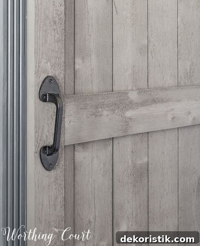 Wrought iron gate handle used on diy sliding barn door.