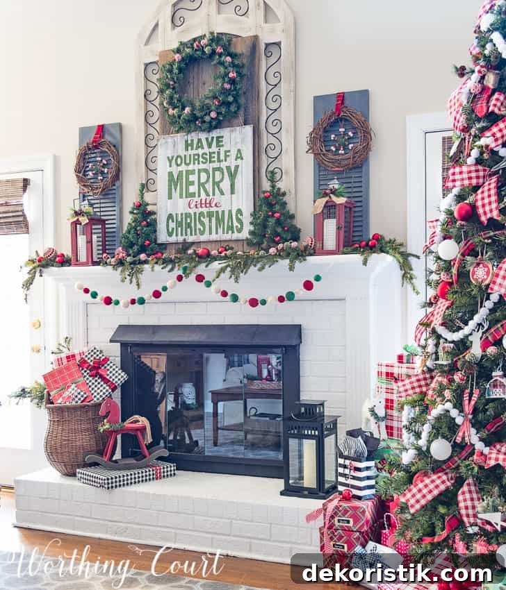 Farmhouse Christmas mantel decorated with traditional red and green with a large decorated Christmas tree beside it.