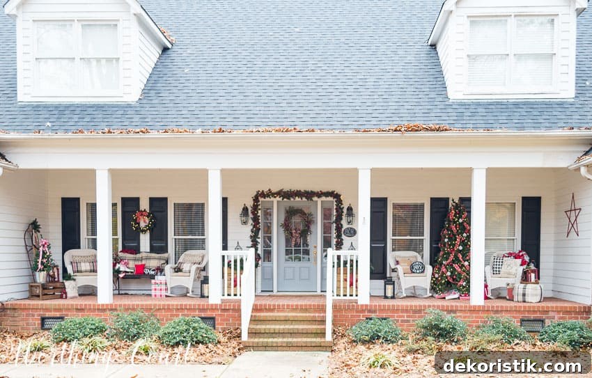 A large urban covered porch decorated in the farmhouse theme for Christmas.