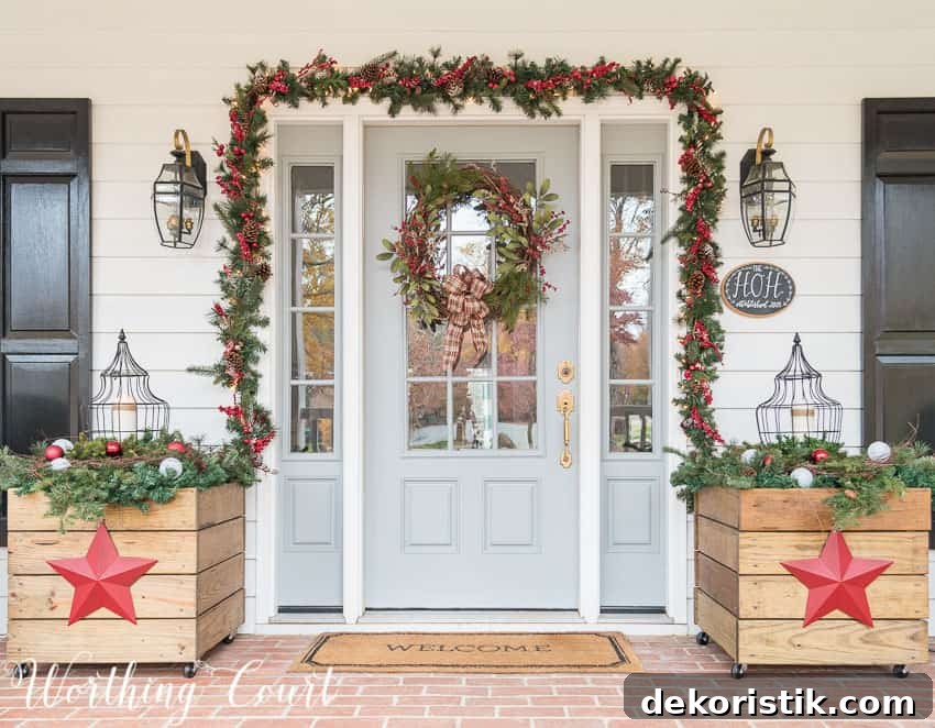 Front door surrounded with lighted garland and flanked with diy planters for Christmas.