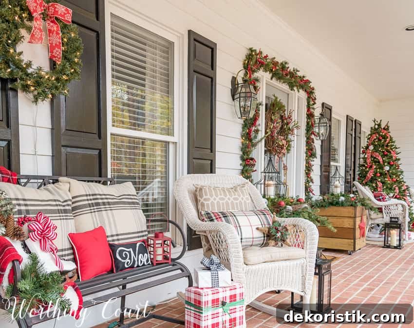 White wicker chairs with holiday throw pillows on the porch.