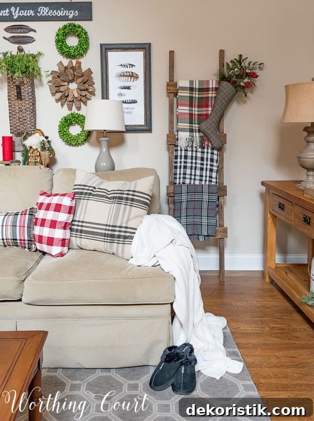 DIY rustic ladder with a variety of plaid Christmas throws in the family room.