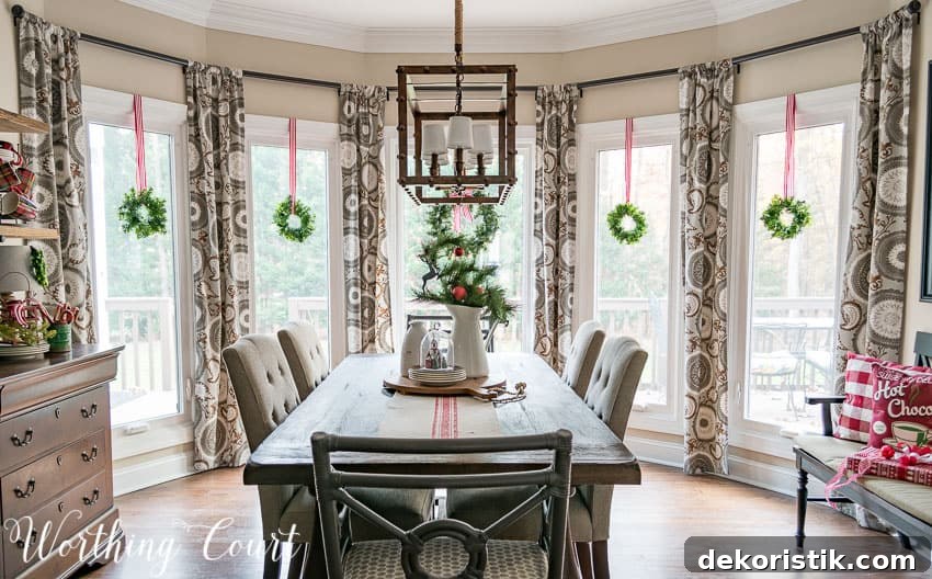 Farmhouse Christmas Breakfast Nook Decor Ideas 12 Christmas breakfast nook with wreaths in the bay windows.