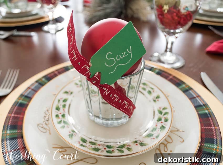 Votive place cards with a red ribbon and a tag that says Suzy.