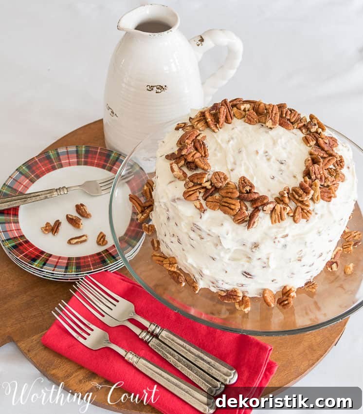 Recipe for classic red velvet cake with cream cheese icing and pecans on the top and side of the cake.