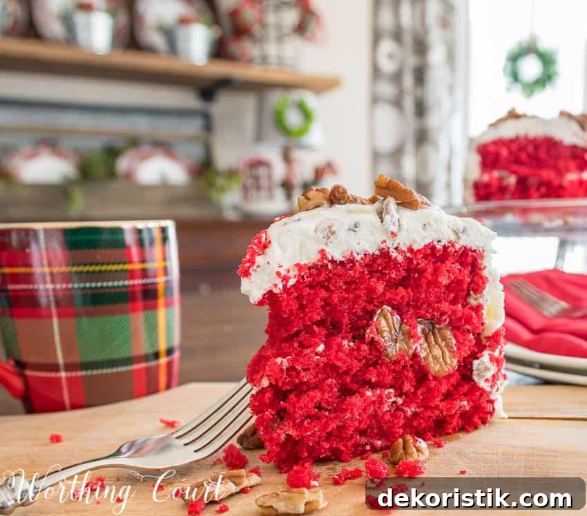 A slice of the cake is on the table revealing a bright red centre.