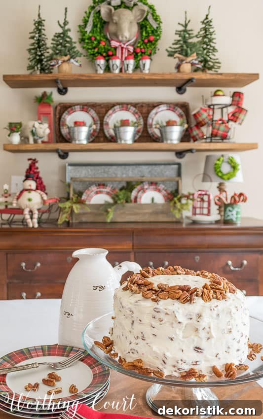 The red velvet cake is on the table with decorated open shelves behind it.