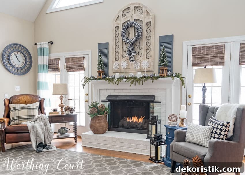 A white fireplace with two armchairs flanking it.