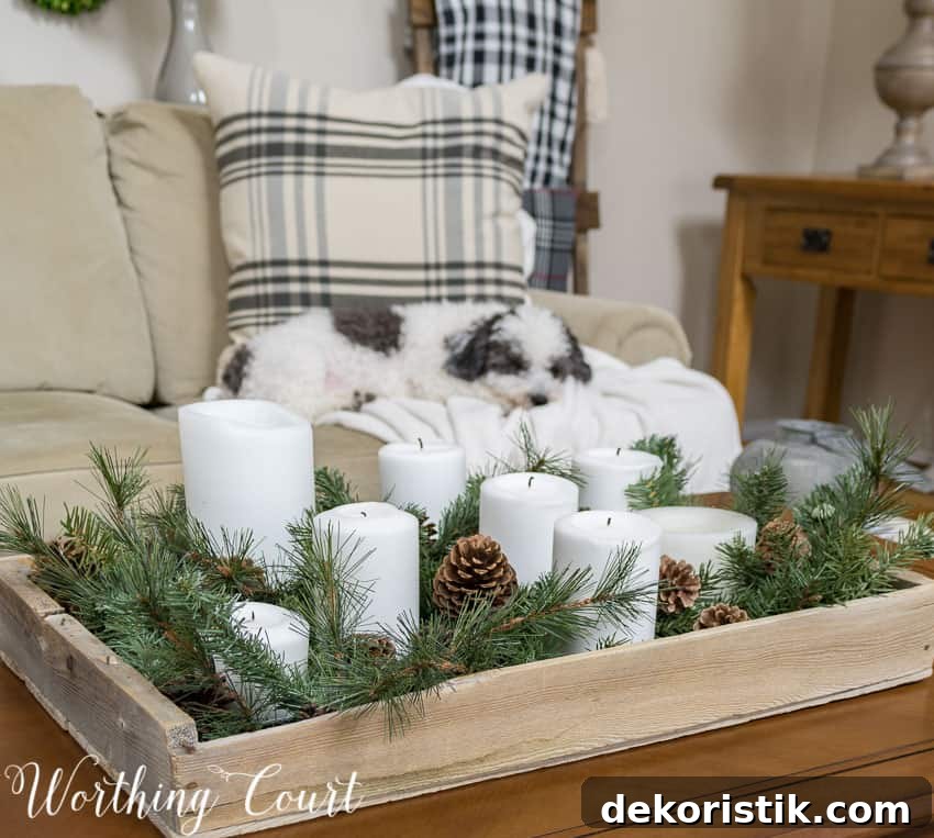 A candle vignette is on the coffee table and a dog is sleeping on the couch. 