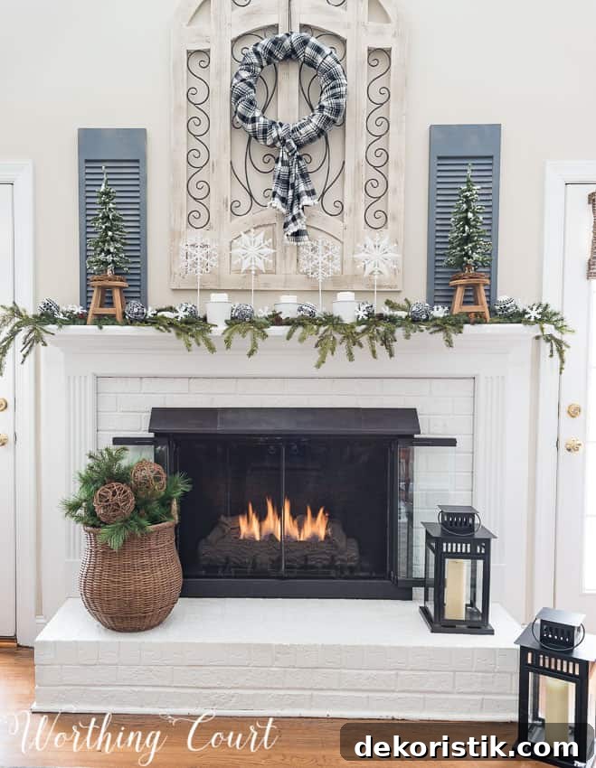 Painted red brick fireplace with winter decor.
