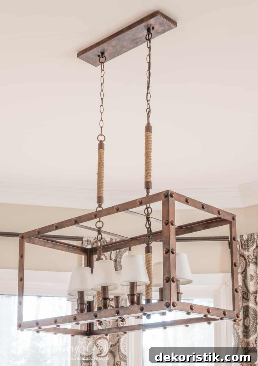 Up close shot of the square light fixture over the dining room table.