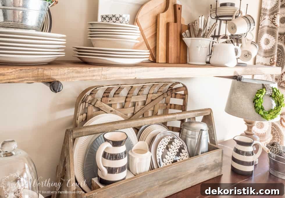 A vintage looking wood toolbox filled with white, gray and black plates looks right at home on the sideboard of a farmhouse style breakfast area and rustic shelf vignette.