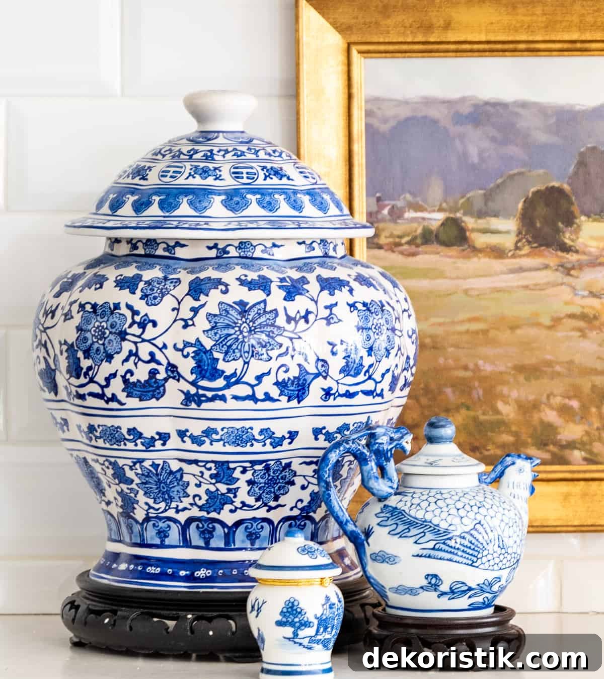 5 Decorating Rules Interior Designers Swear By for Your Home 3 blue and white accessories in front of a white tile backsplash on a kitchen counter